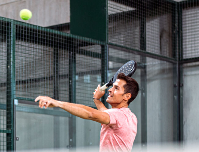 man hitting the ball with a squash racket